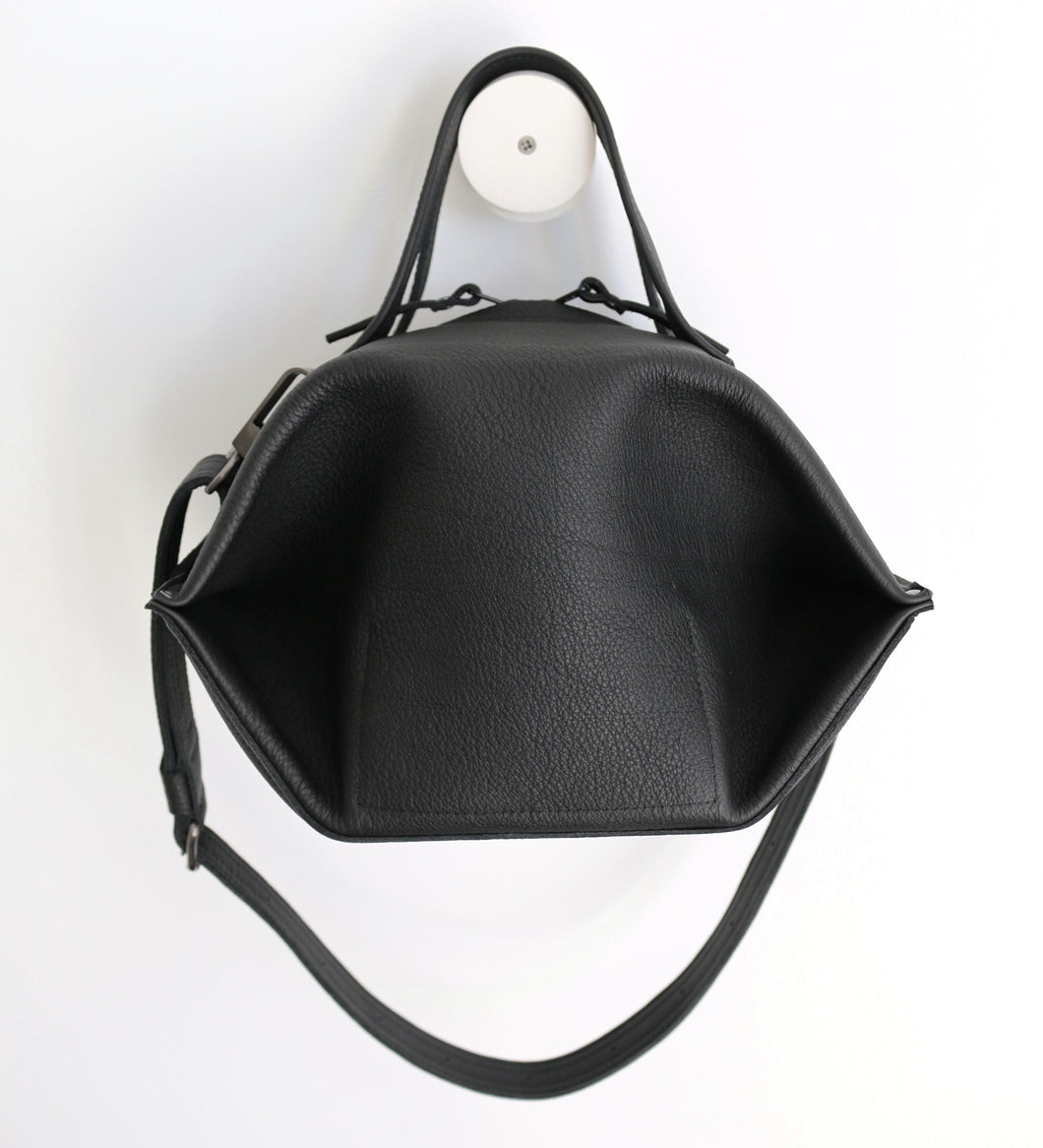 pumpkin frrry. foldable bag. black leather. round shape. plump. zipper closure.