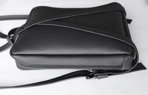 Fig backpack frrry black. side view. zipper closure. all around.